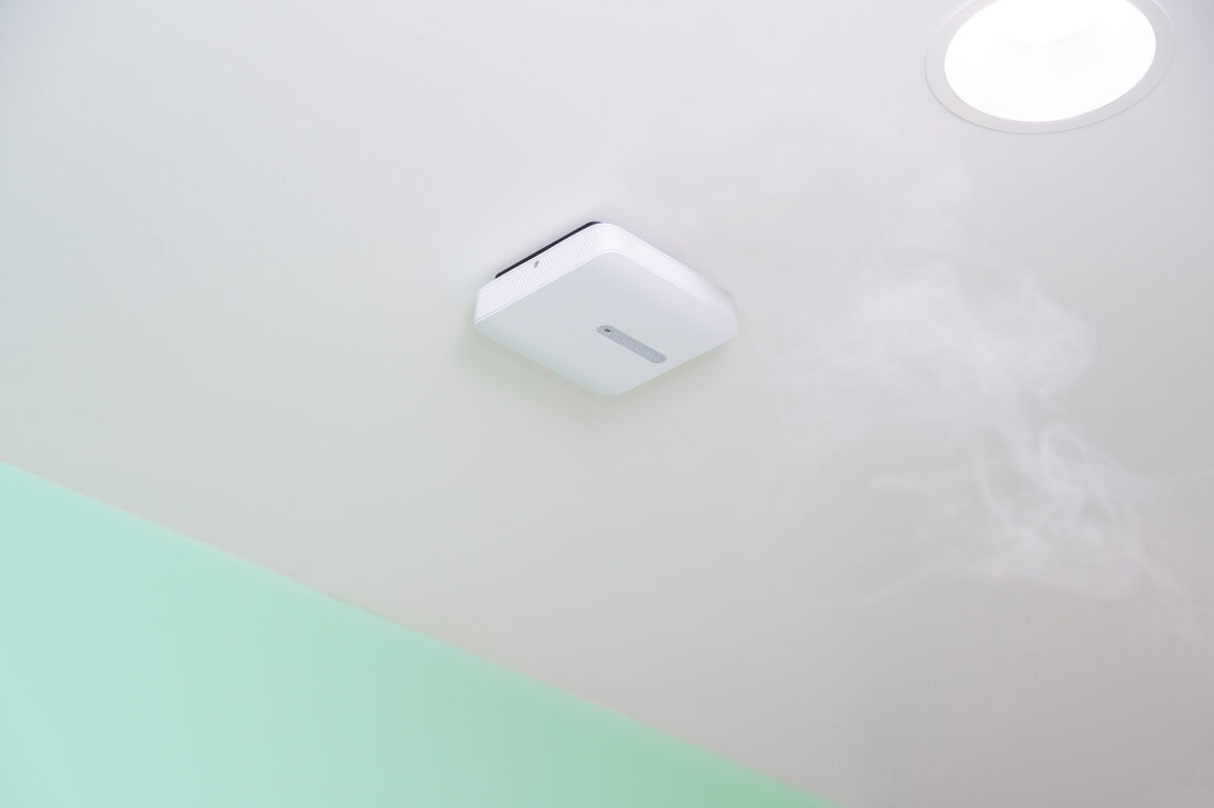 An air-quality sensor on the ceiling of a school washroom